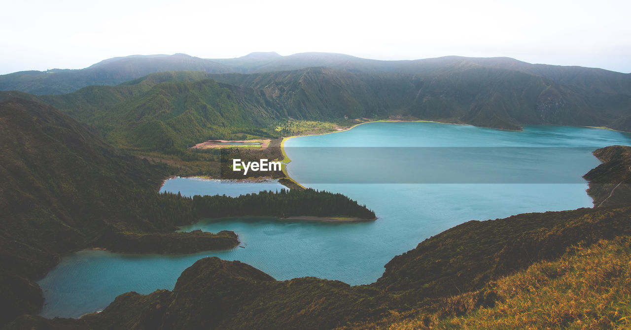 Scenic view of lake and mountains against clear sky