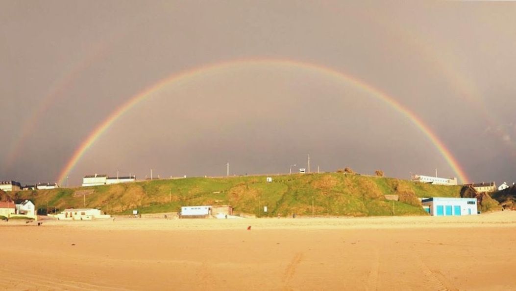 SCENIC VIEW OF RAINBOW OVER LANDSCAPE