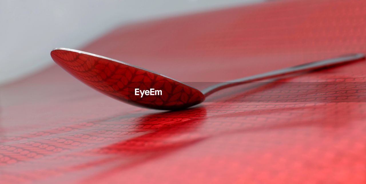 Close-up of spoon on patterned table