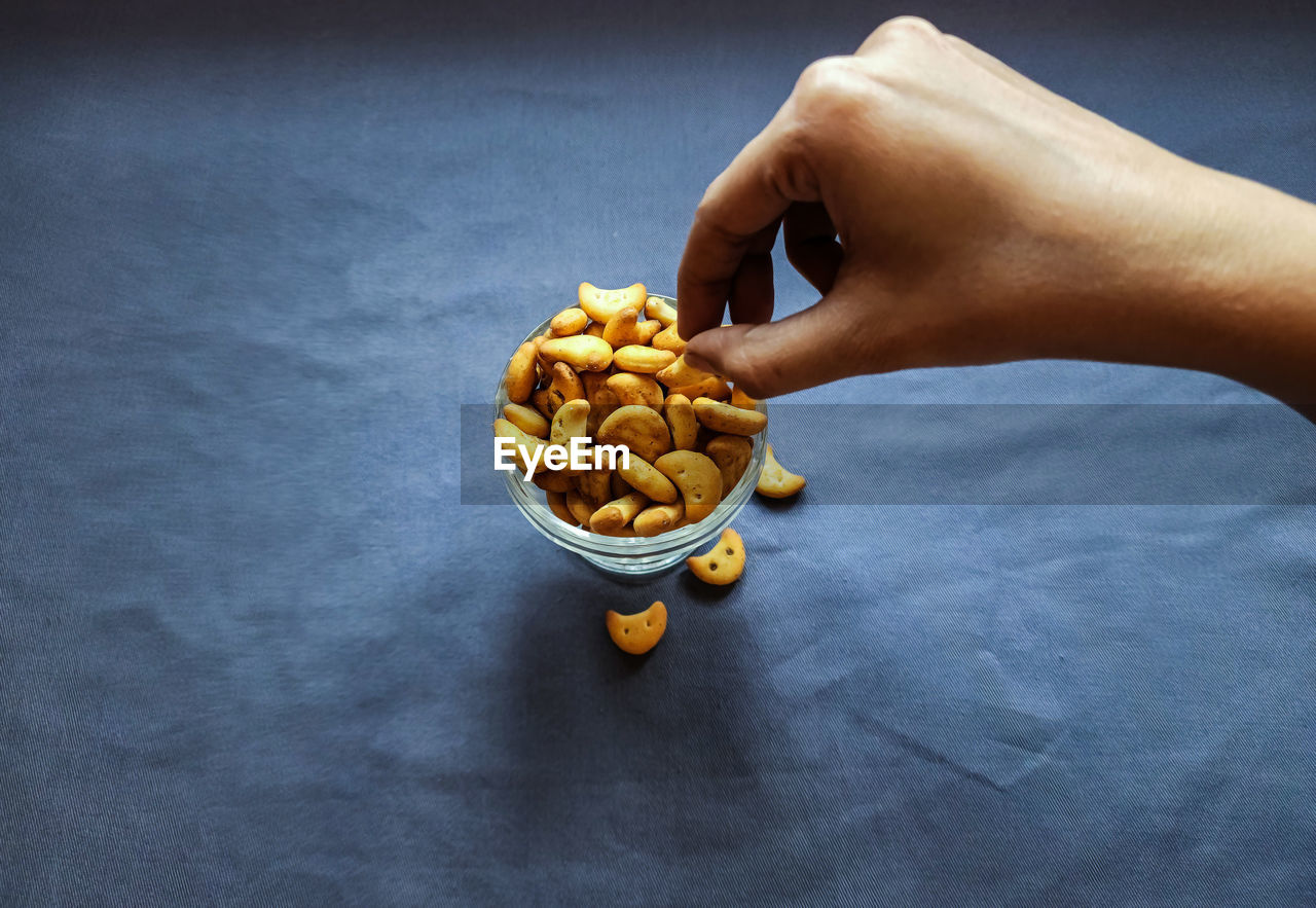 cropped hand of woman holding food