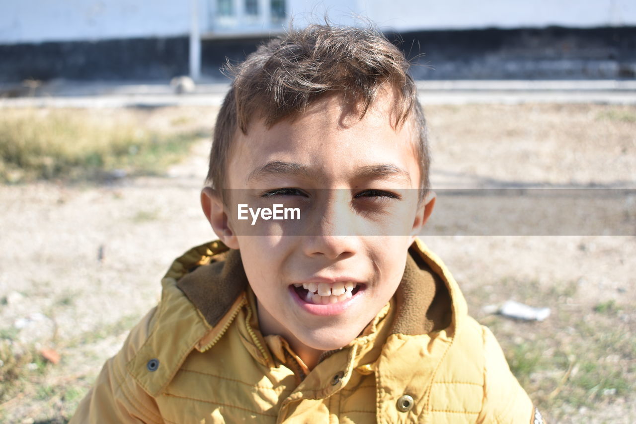 PORTRAIT OF BOY SMILING