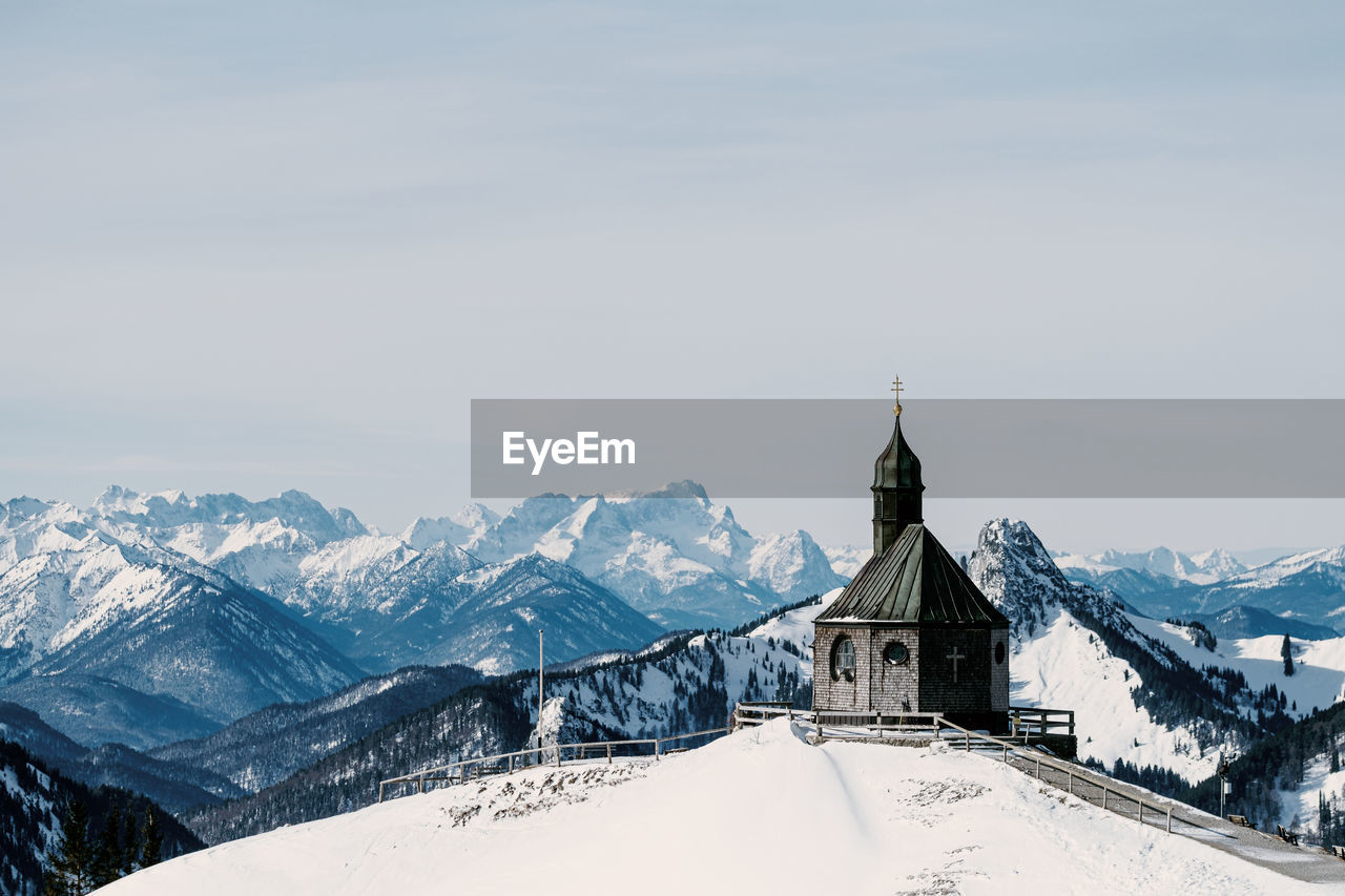 High angle view of old church against mountain view during winter