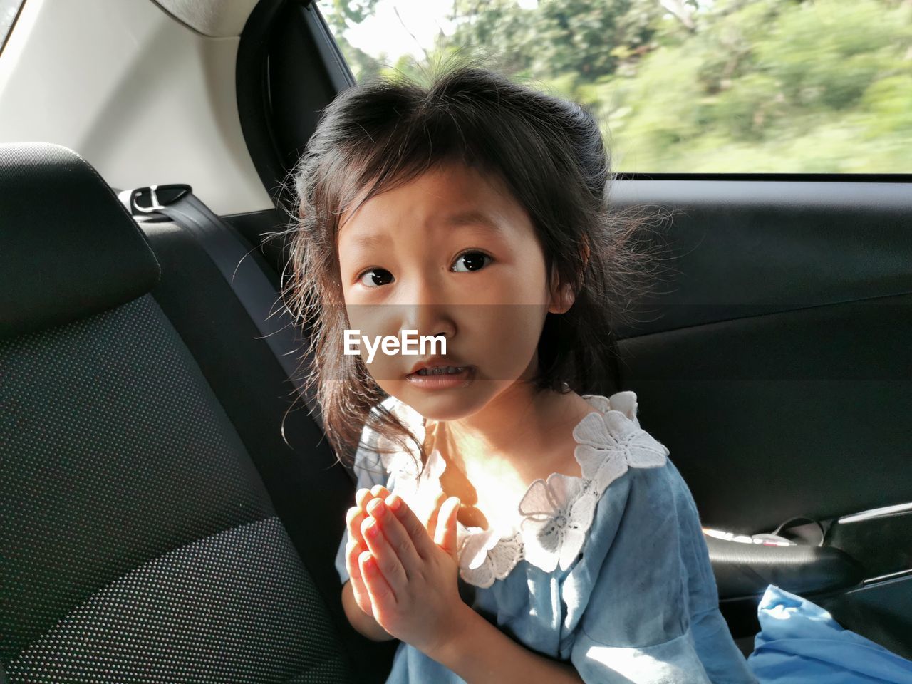 Portrait of girl sitting in car