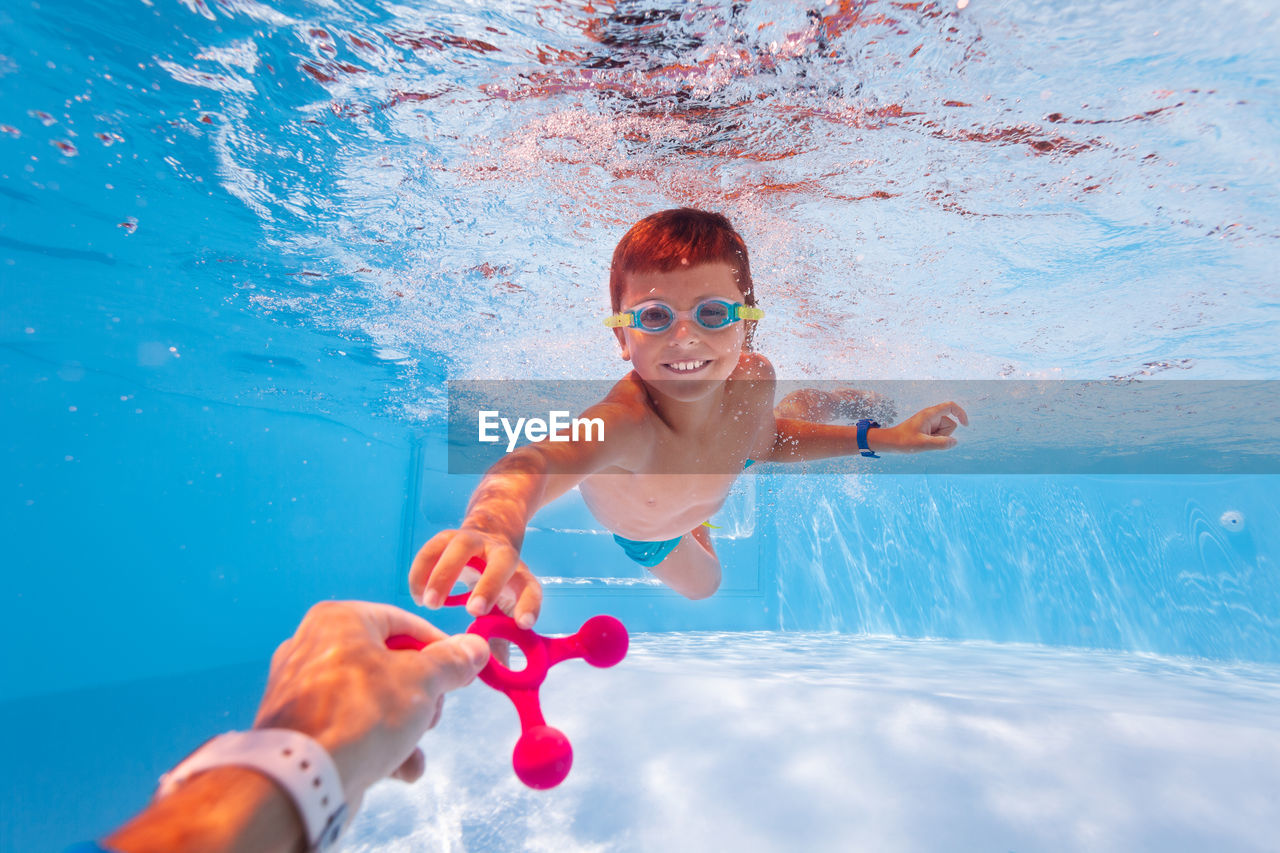 high angle view of boy swimming in sea