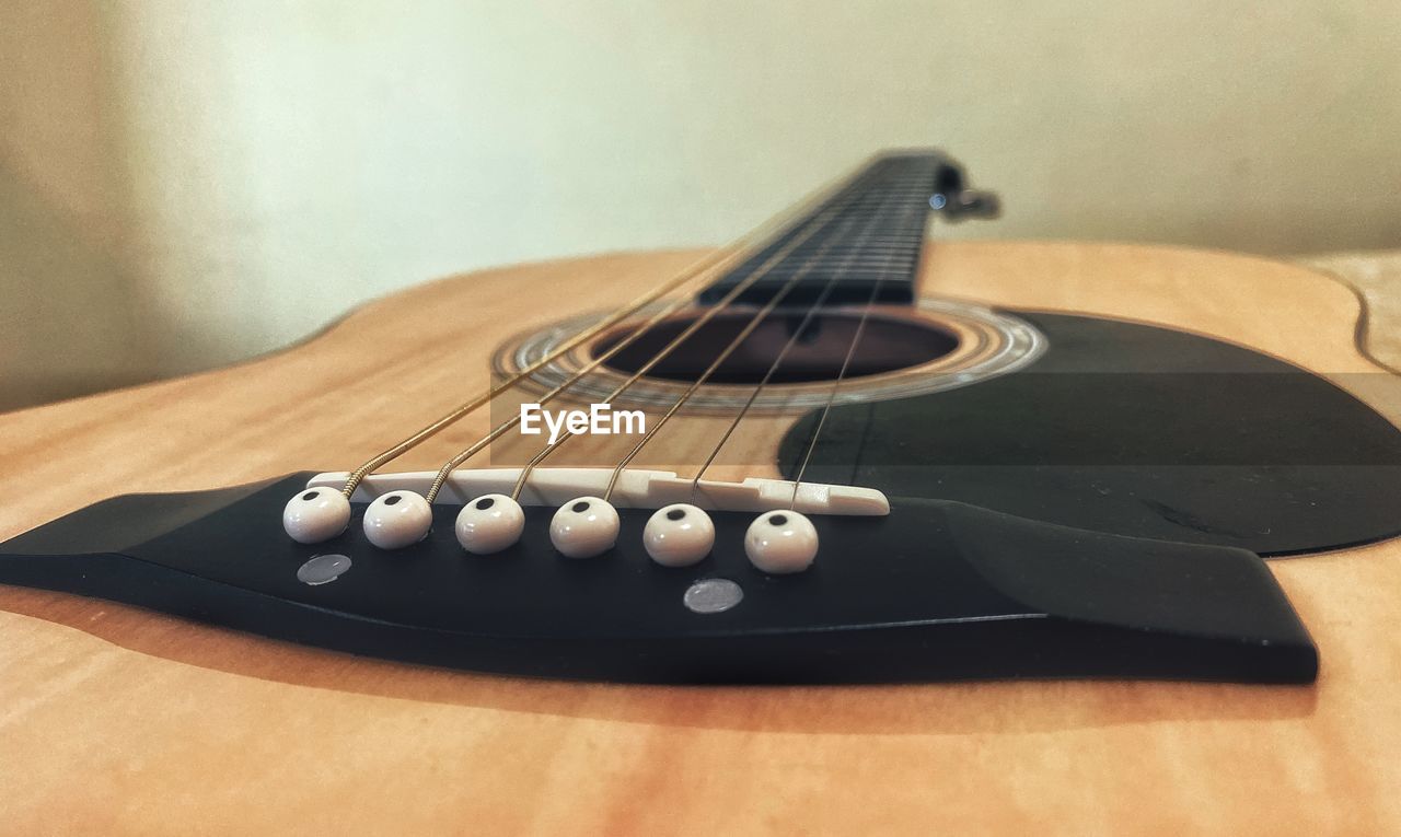 CLOSE-UP OF GUITAR AND TABLE ON STAGE