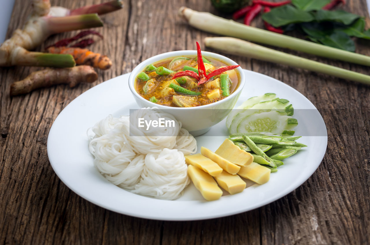 Thai food , fermented rice flour noodles /kanomjeen on wooden table
