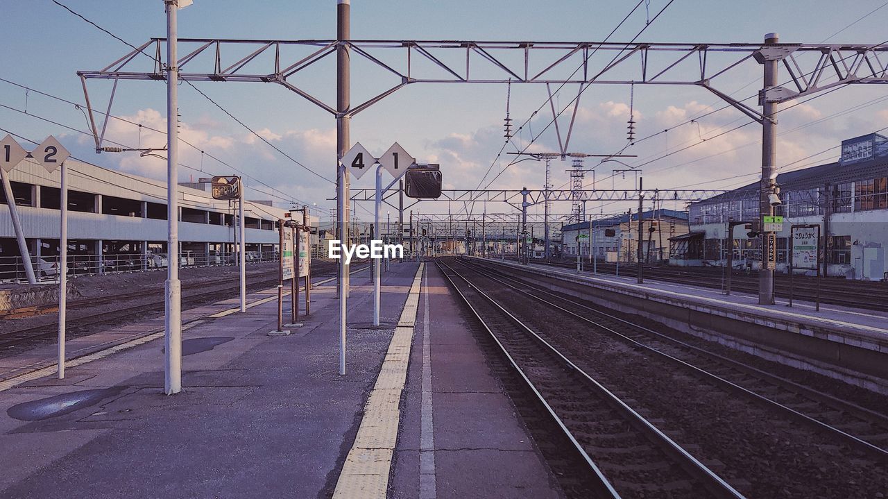 RAILROAD STATION PLATFORM AGAINST SKY