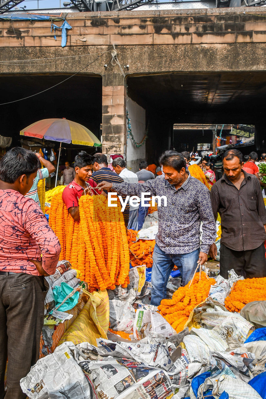 GROUP OF PEOPLE IN MARKET