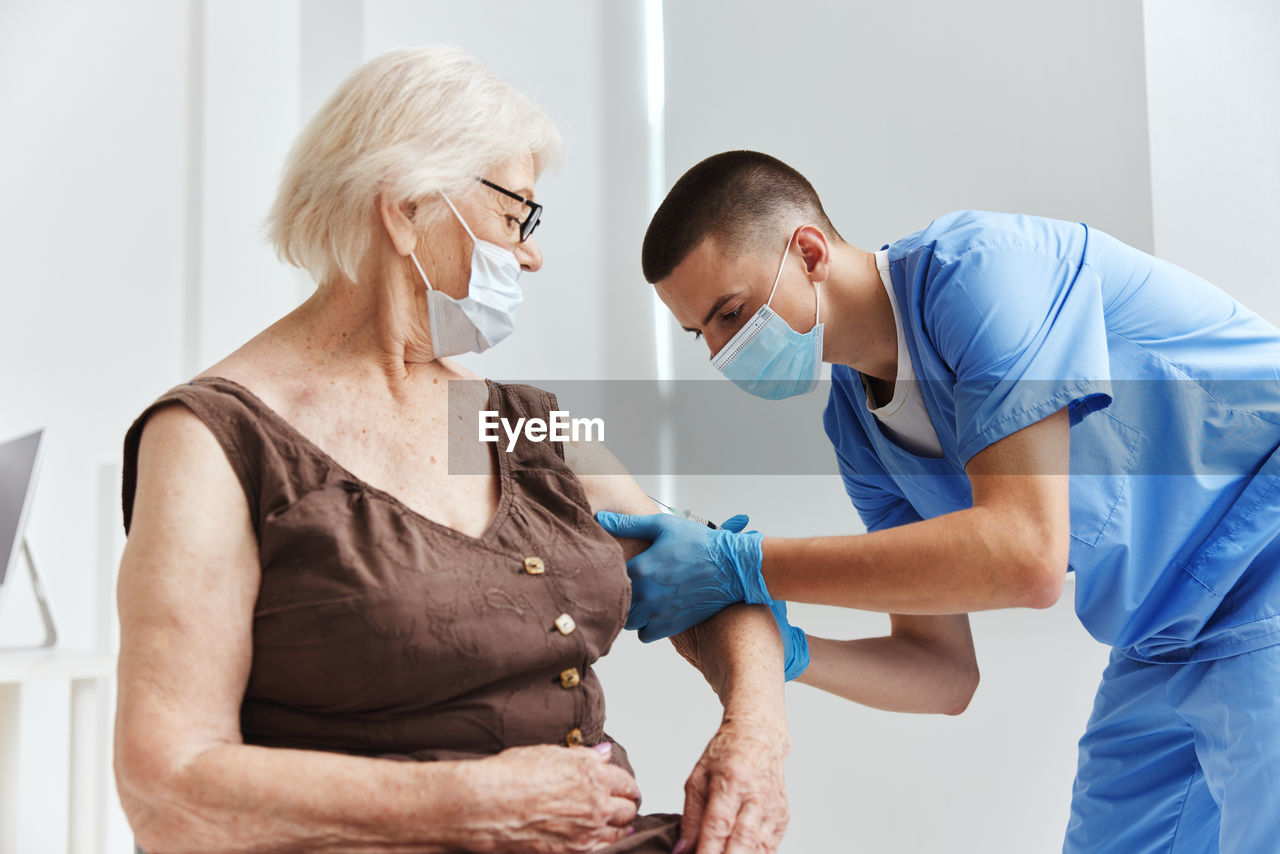 Doctor injecting vaccine to patient
