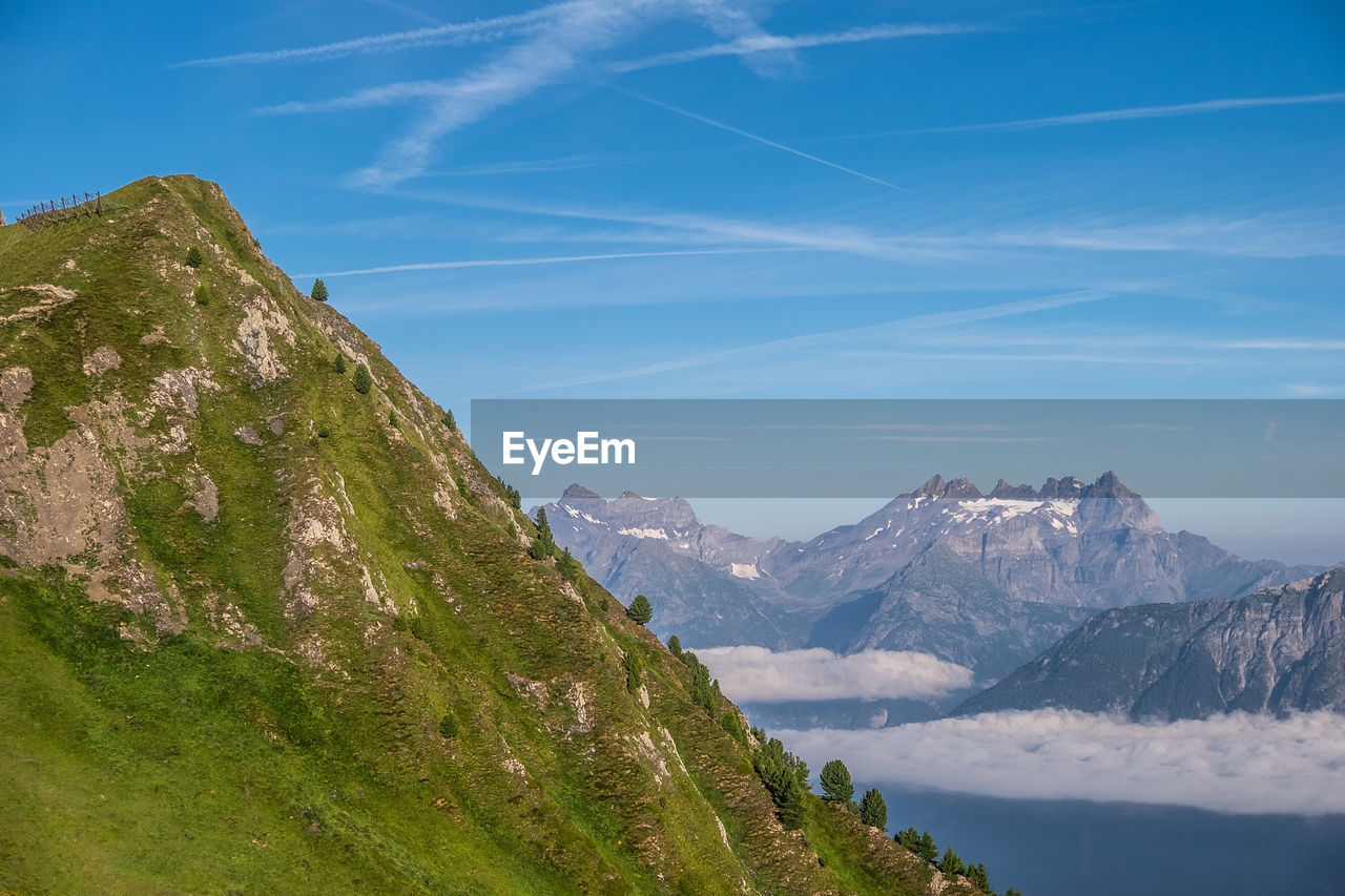 Scenic view of mountains against blue sky