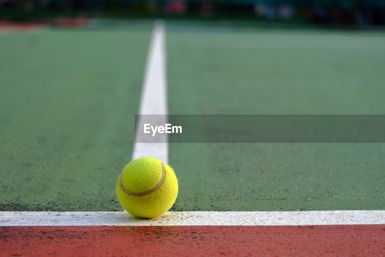 Close-up of tennis ball on line