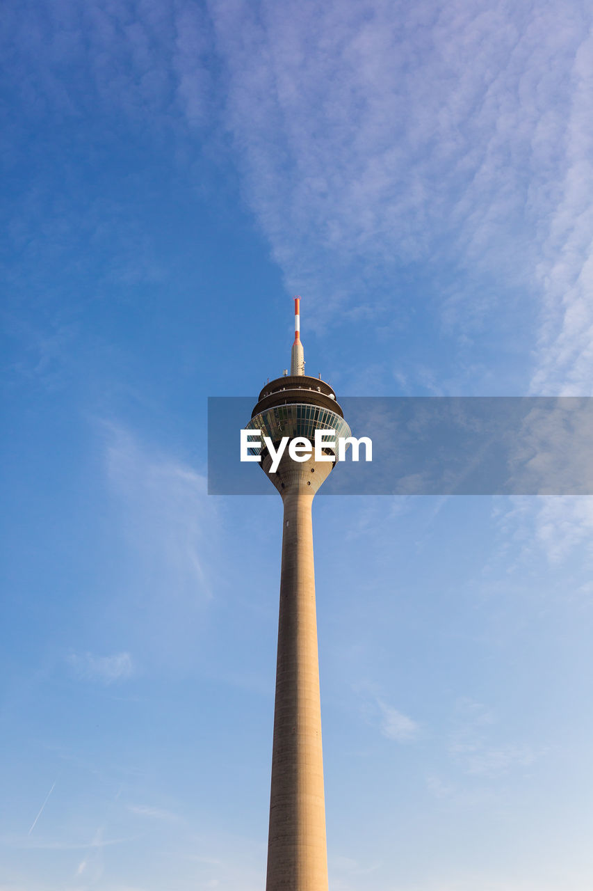 Low angle view of communications tower against sky