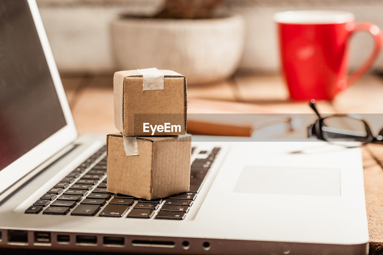 Close-up of cardboard boxes on laptop keyboard