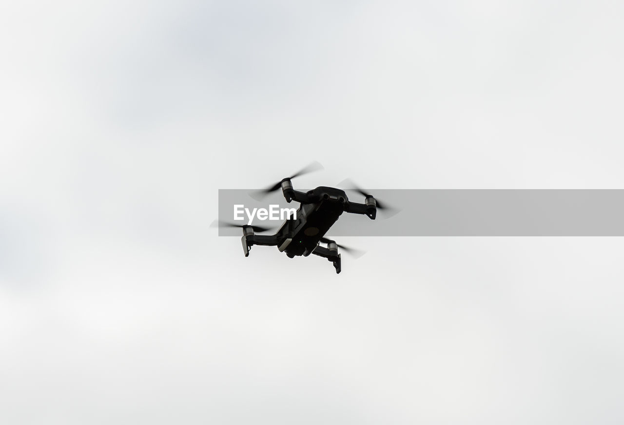 LOW ANGLE VIEW OF AIRPLANE IN FLIGHT AGAINST CLEAR SKY