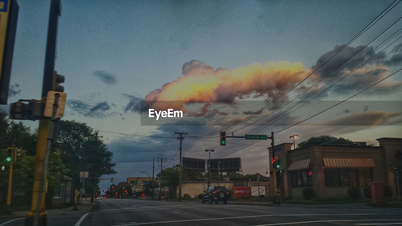 VIEW OF ROAD AGAINST CLOUDY SKY