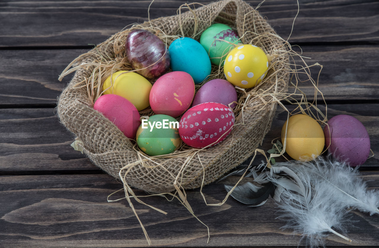 High angle view of easter eggs in jute sack on table