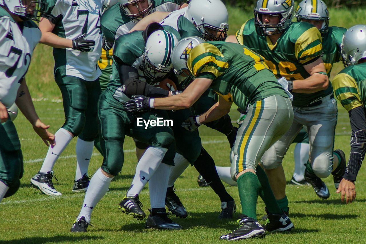 Men tackling in american football sport