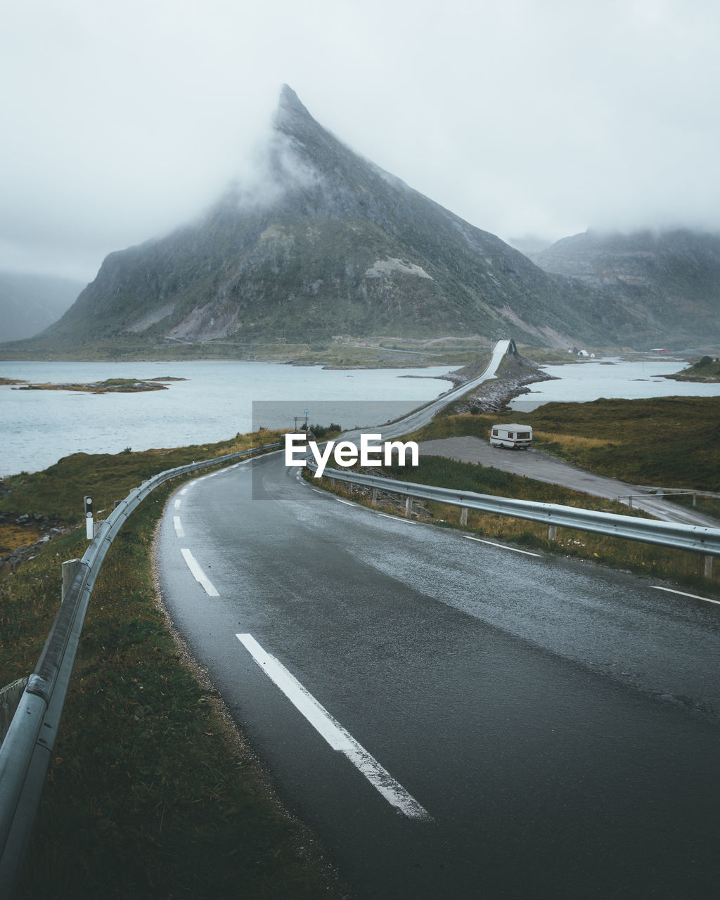 Road by mountain against sky