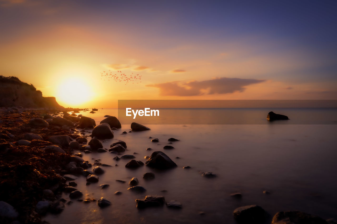 SCENIC VIEW OF SEA DURING SUNSET