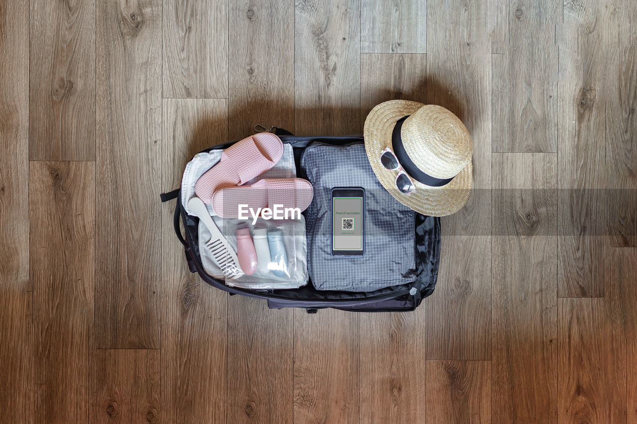 HIGH ANGLE VIEW OF HAT ON HARDWOOD FLOOR AT HOME