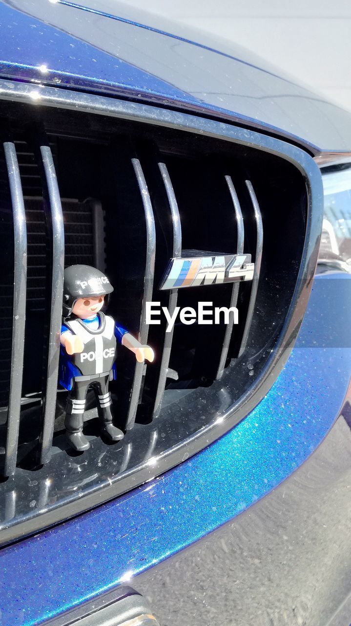 CLOSE-UP HIGH ANGLE VIEW OF MAN ON CAR