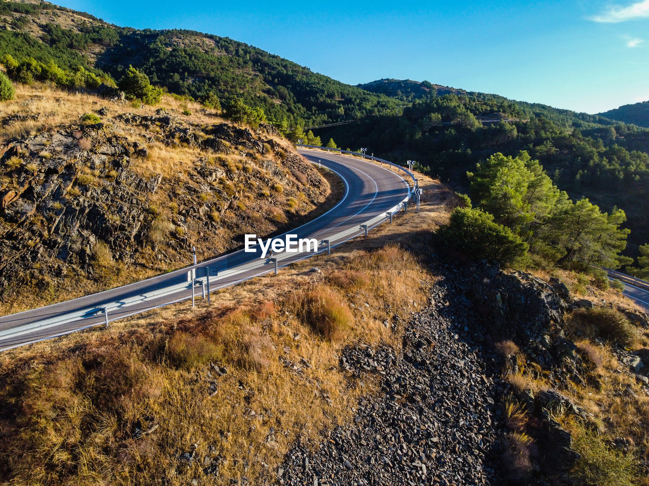 Winding mountain road in madrid, aerial drone view