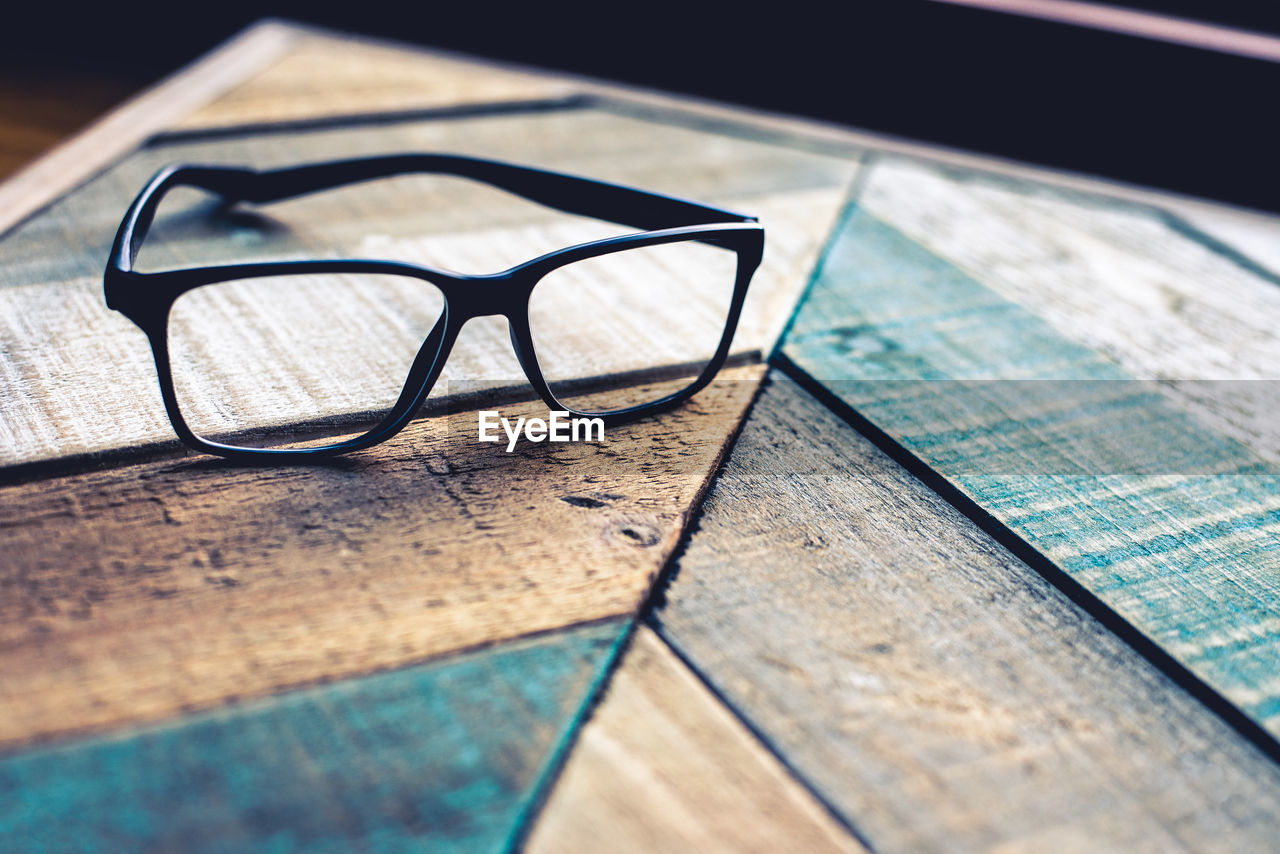 Close-up of eyeglasses on wooden table