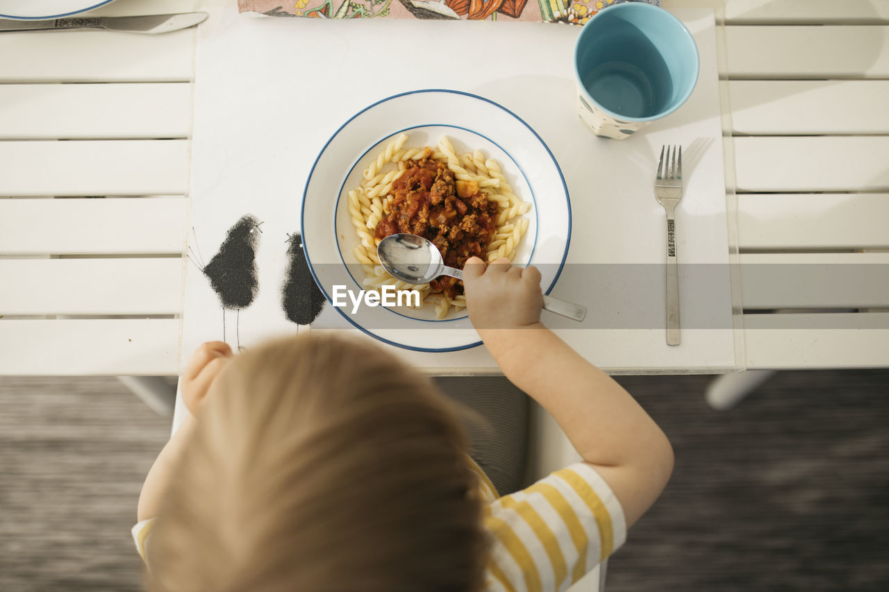 Toddler having pasta meal