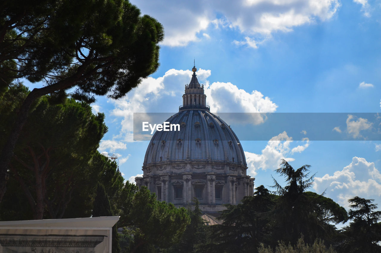 High section of st peter basilica by trees against sky