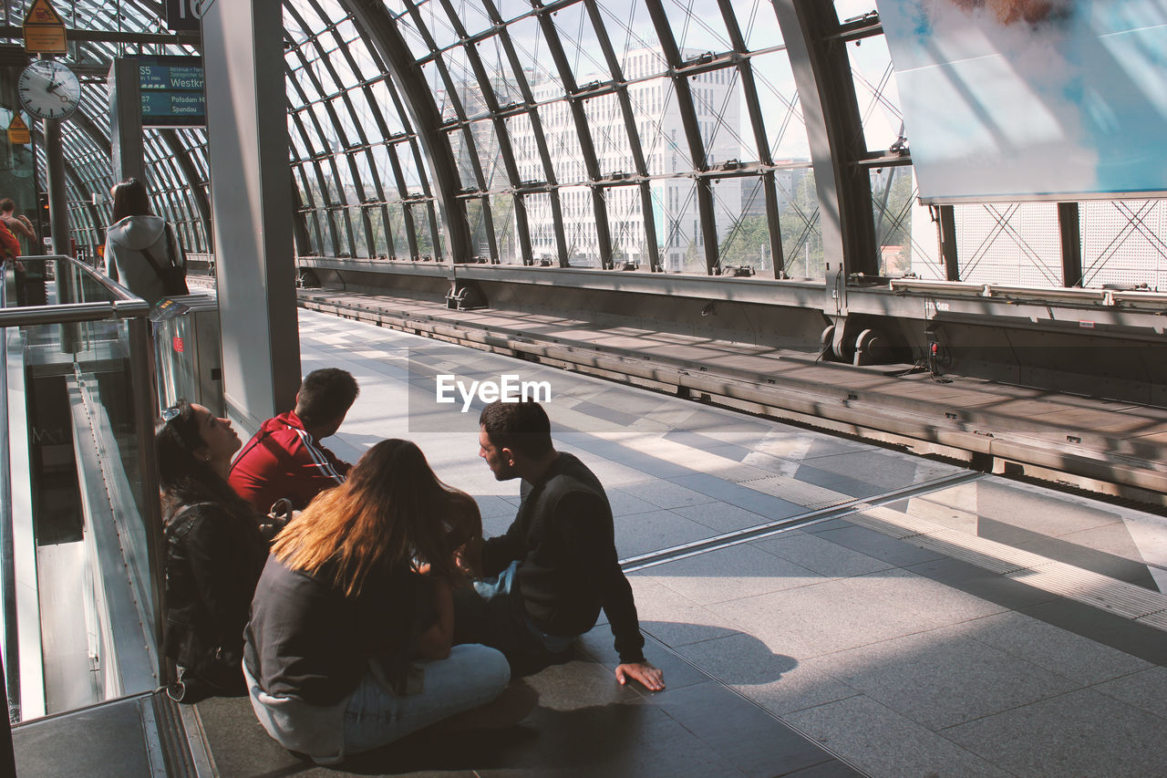 PEOPLE SITTING AT WINDOW