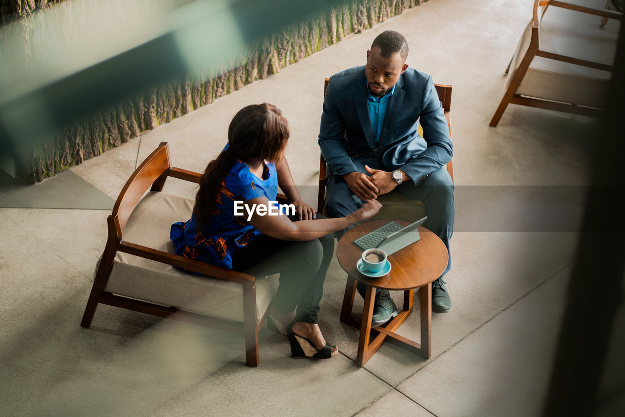 Business person having discussion while sitting in office