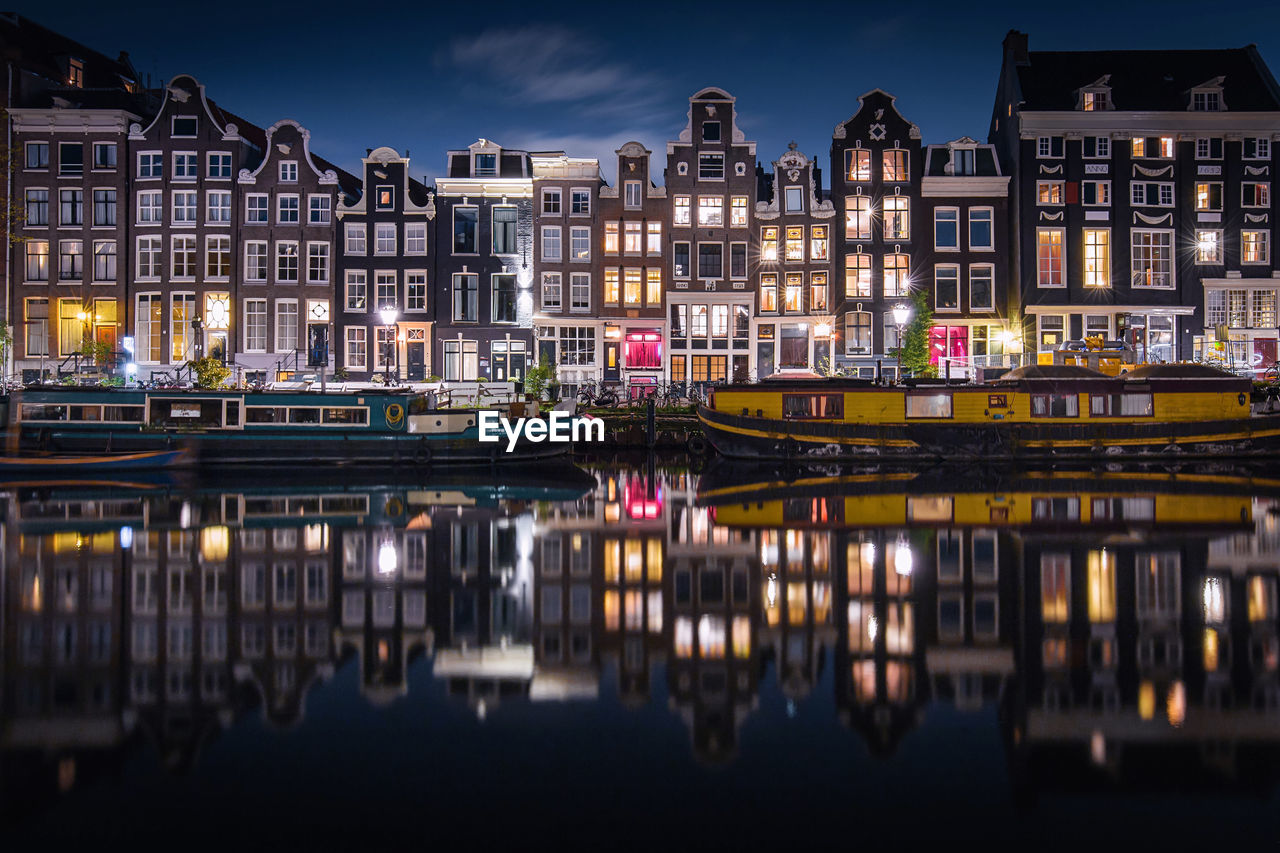 Reflection of illuminated buildings in river at night