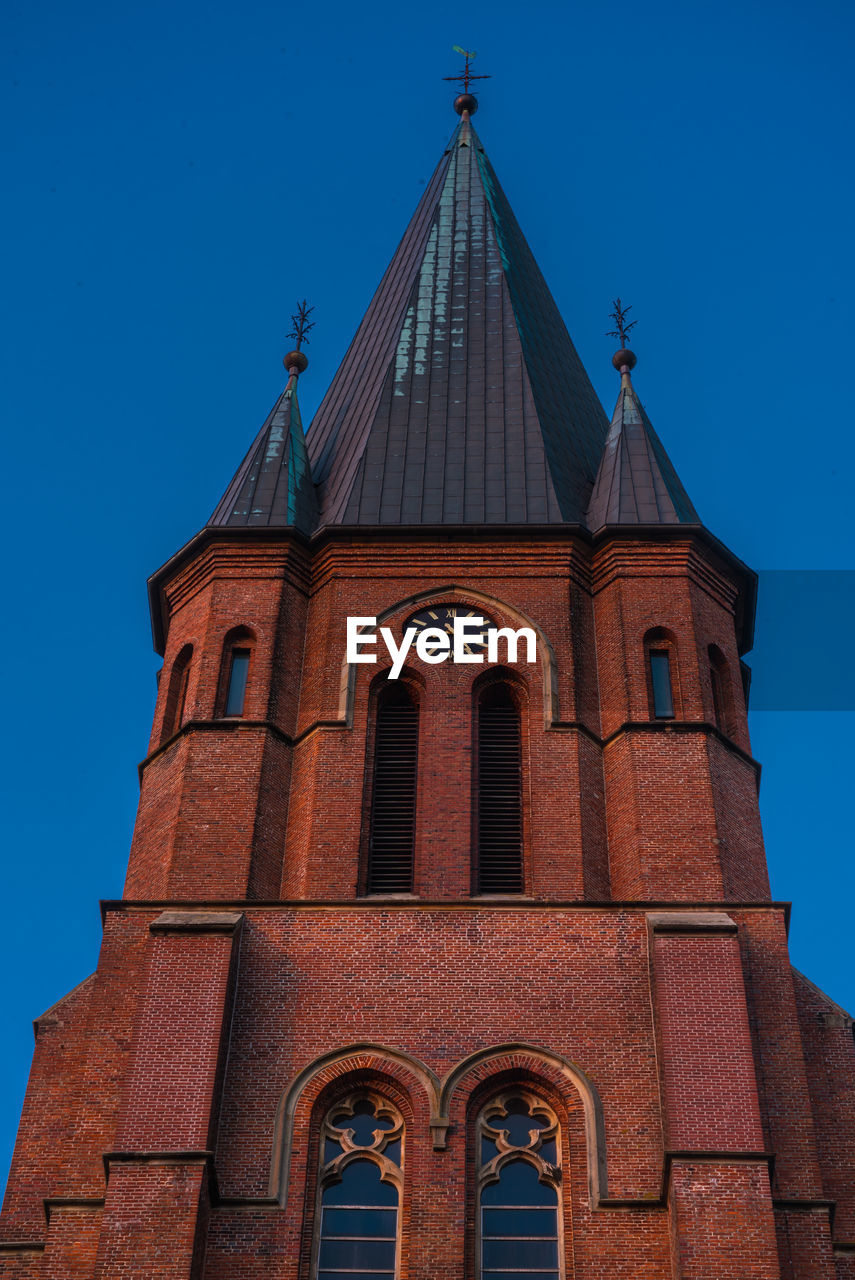 Low angle view of building against clear blue sky