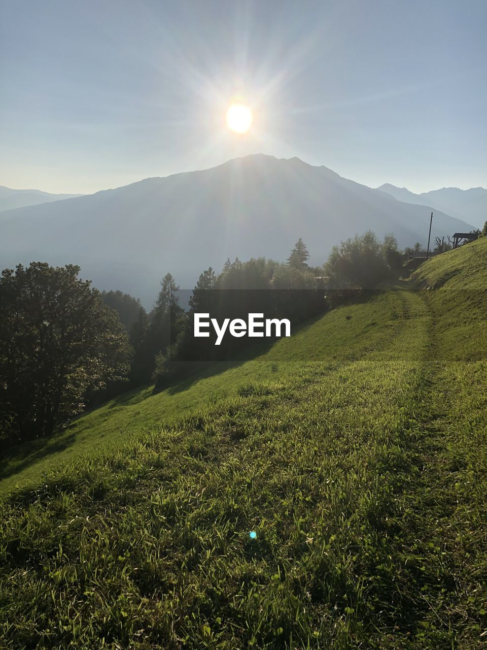 SCENIC VIEW OF FIELD AND MOUNTAINS AGAINST SKY