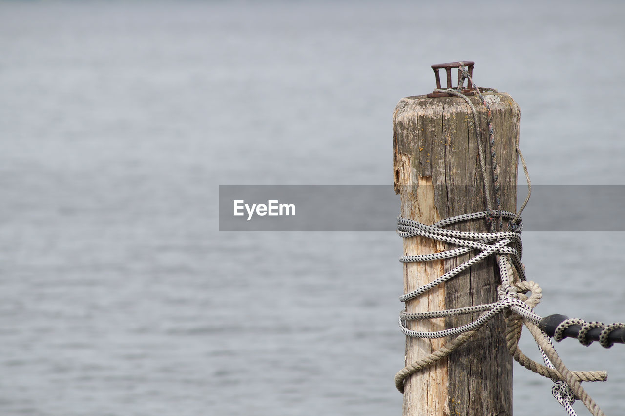 Wooden post by sea