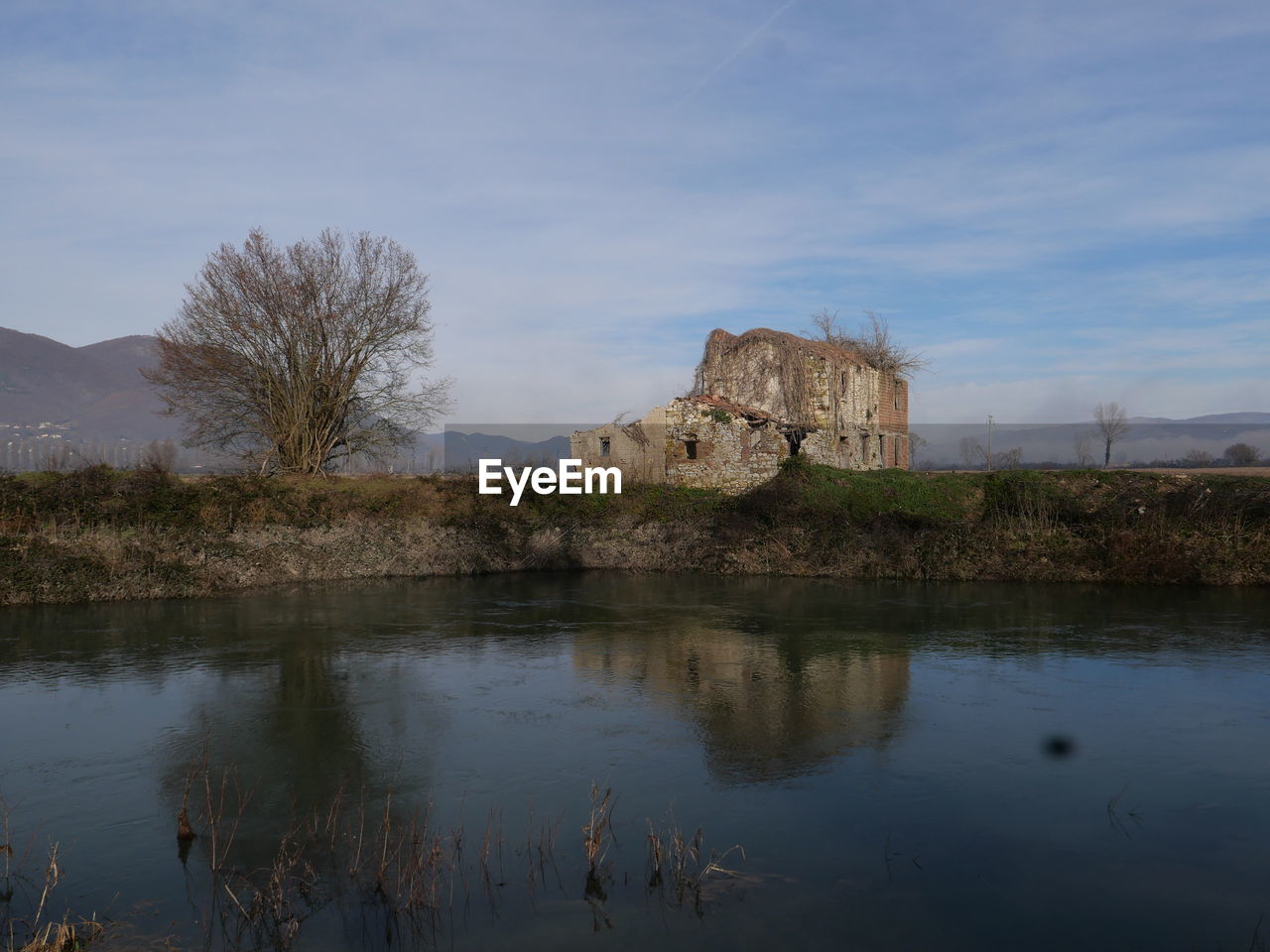 reflection, water, sky, landscape, nature, architecture, river, history, plant, the past, built structure, no people, tree, travel destinations, cloud, scenics - nature, castle, morning, tranquility, beauty in nature, mountain, reservoir, outdoors, rural area, building exterior, building, day, travel, tourism, tranquil scene, land, environment, non-urban scene, ancient, old ruin, rock