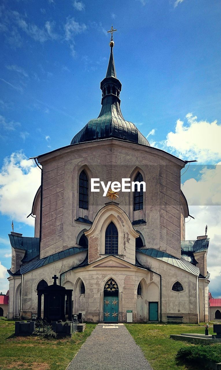 Low angle view of church against cloudy sky