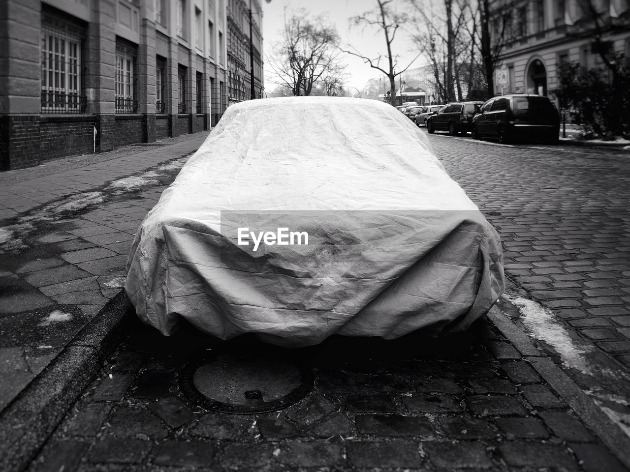 Covered car on street