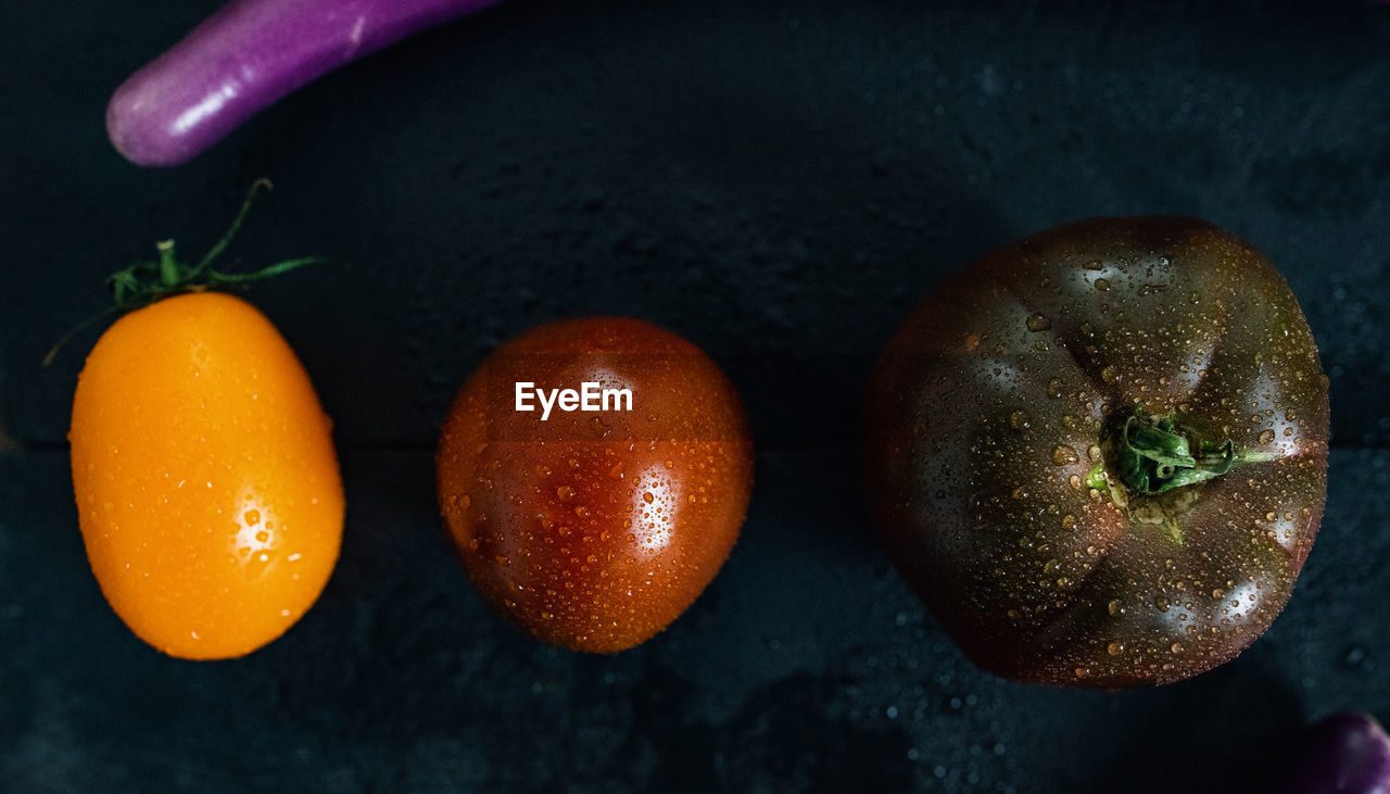 High angle view of wet colorful tomatoes on table