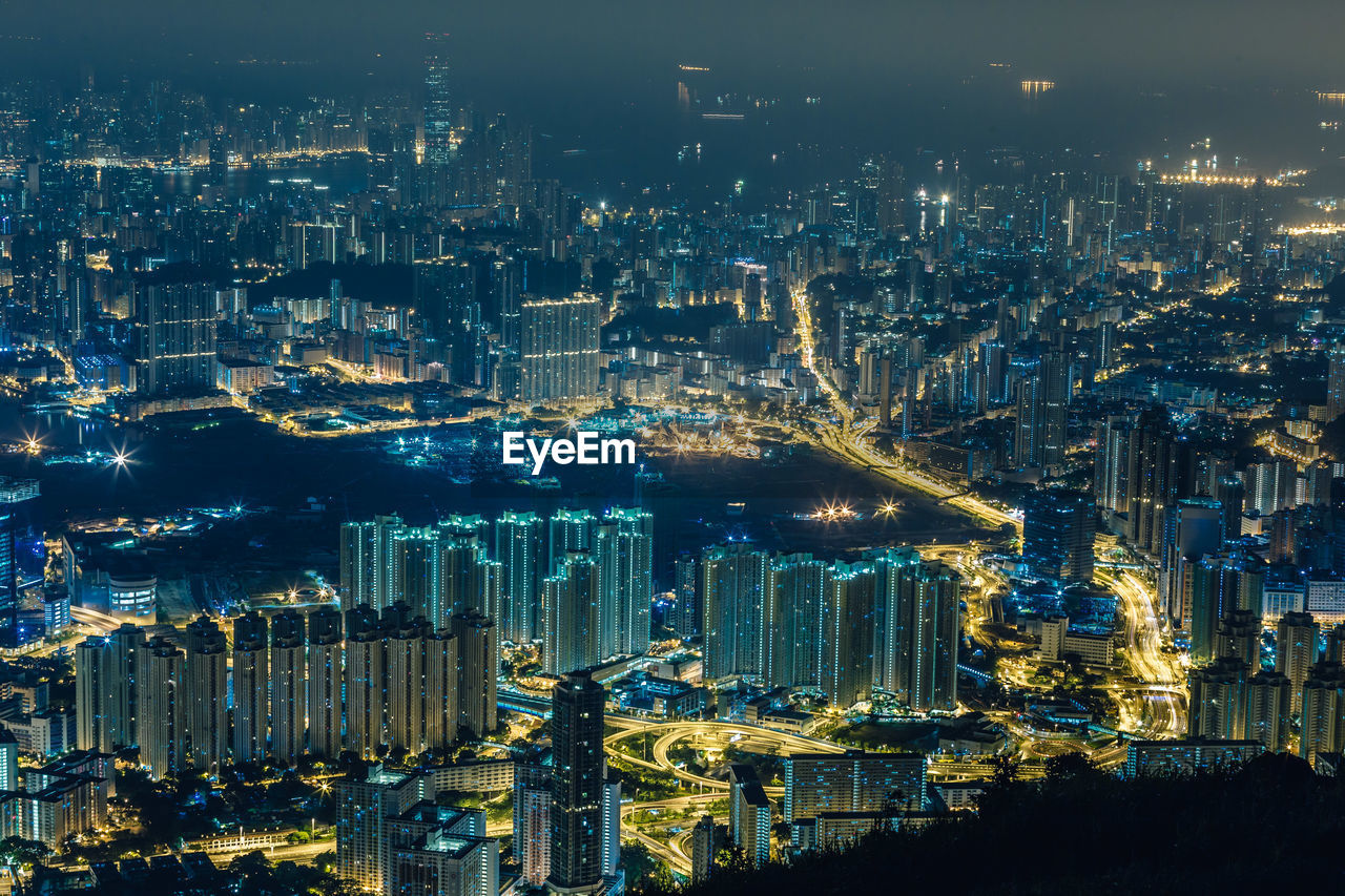 High angle view of illuminated buildings in city at night