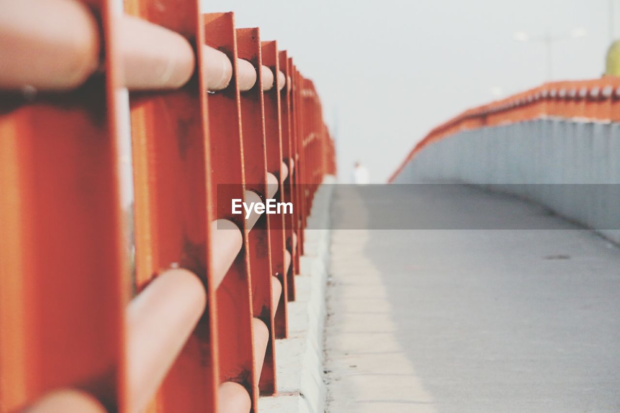 Close-up of red footbridge railing