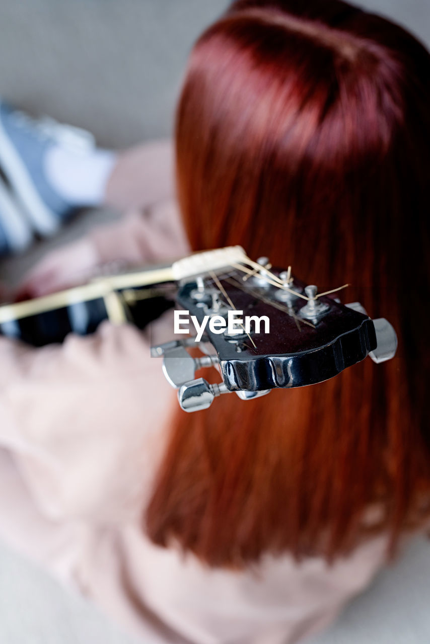 Close-up of woman playing guitar