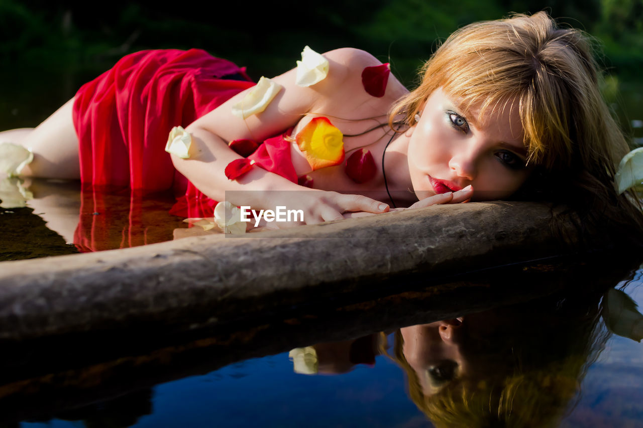 Front view of young woman looking at river