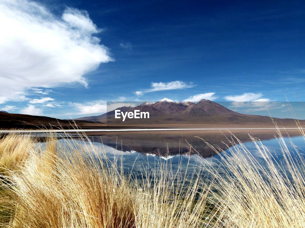 SCENIC VIEW OF MOUNTAINS AGAINST CLOUDY SKY