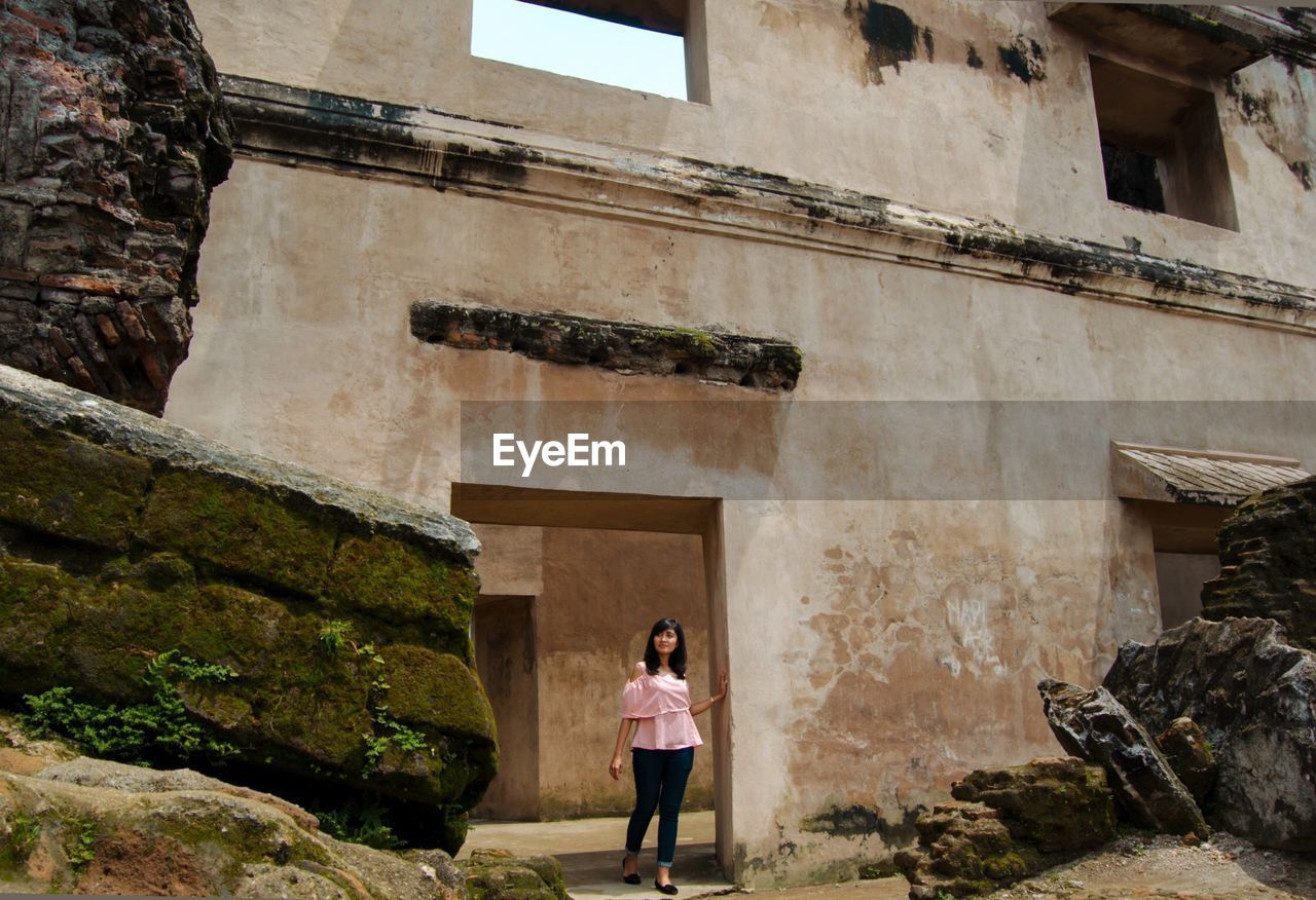 Full length of woman walking on doorway at taman sari water castle