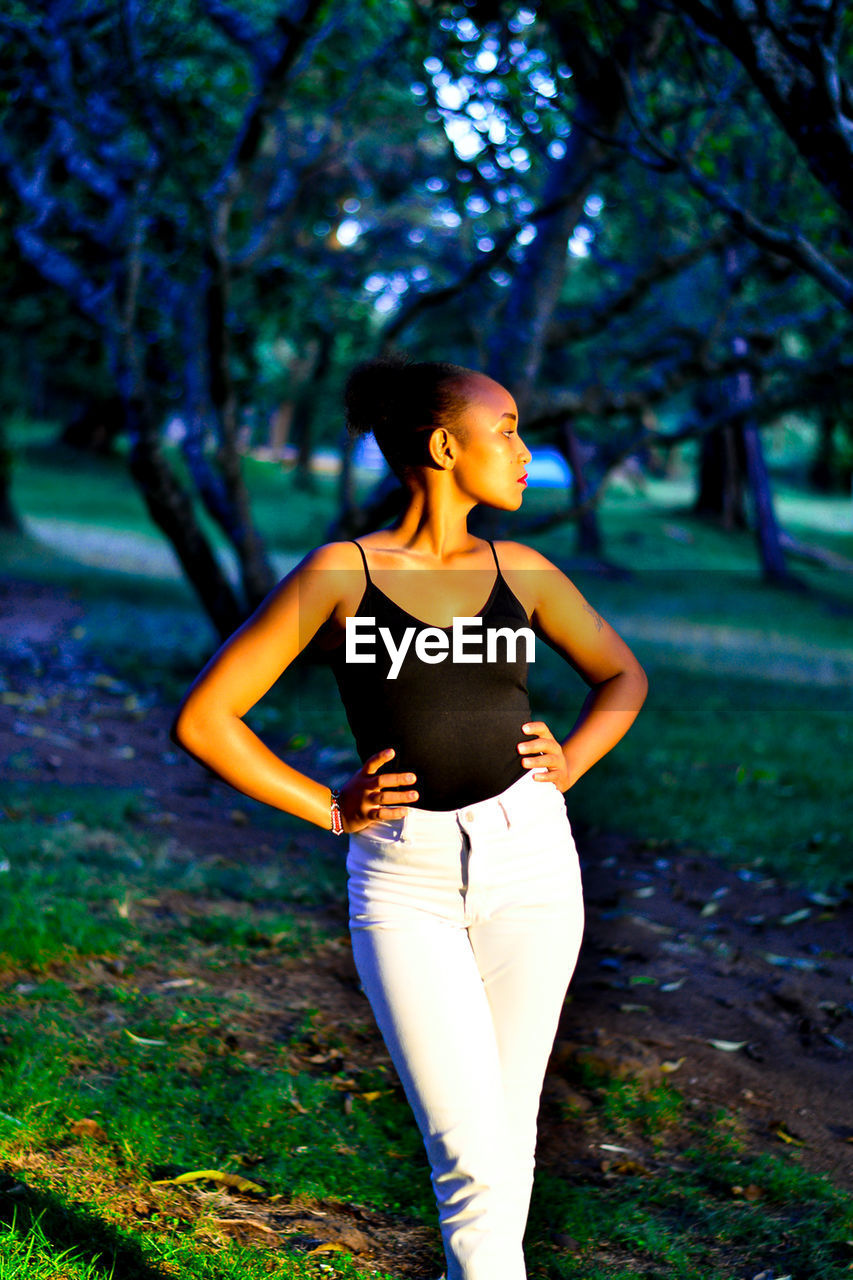 Confident woman standing on field