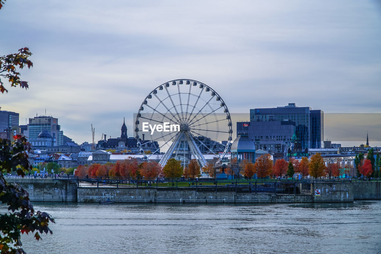 Ferris wheel in city against sky