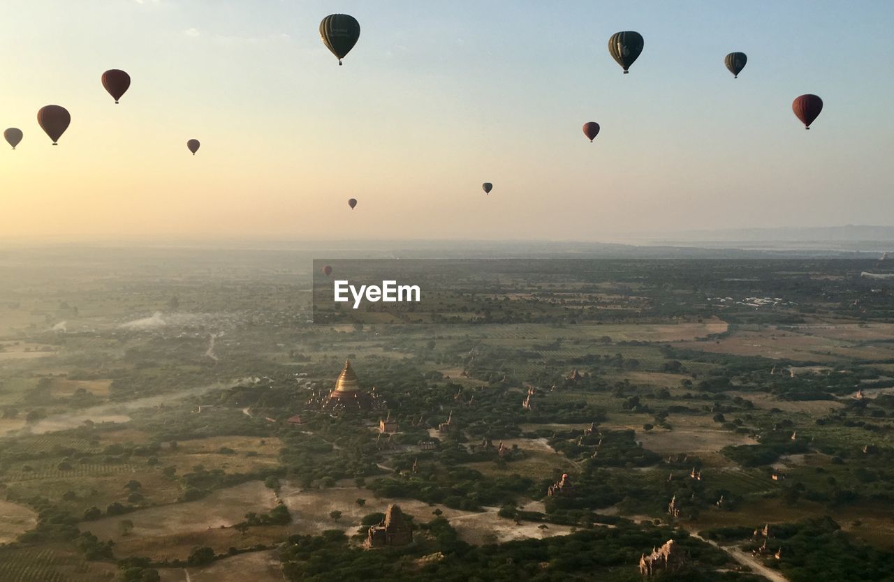 Aerial view of hot air balloons flying in sky