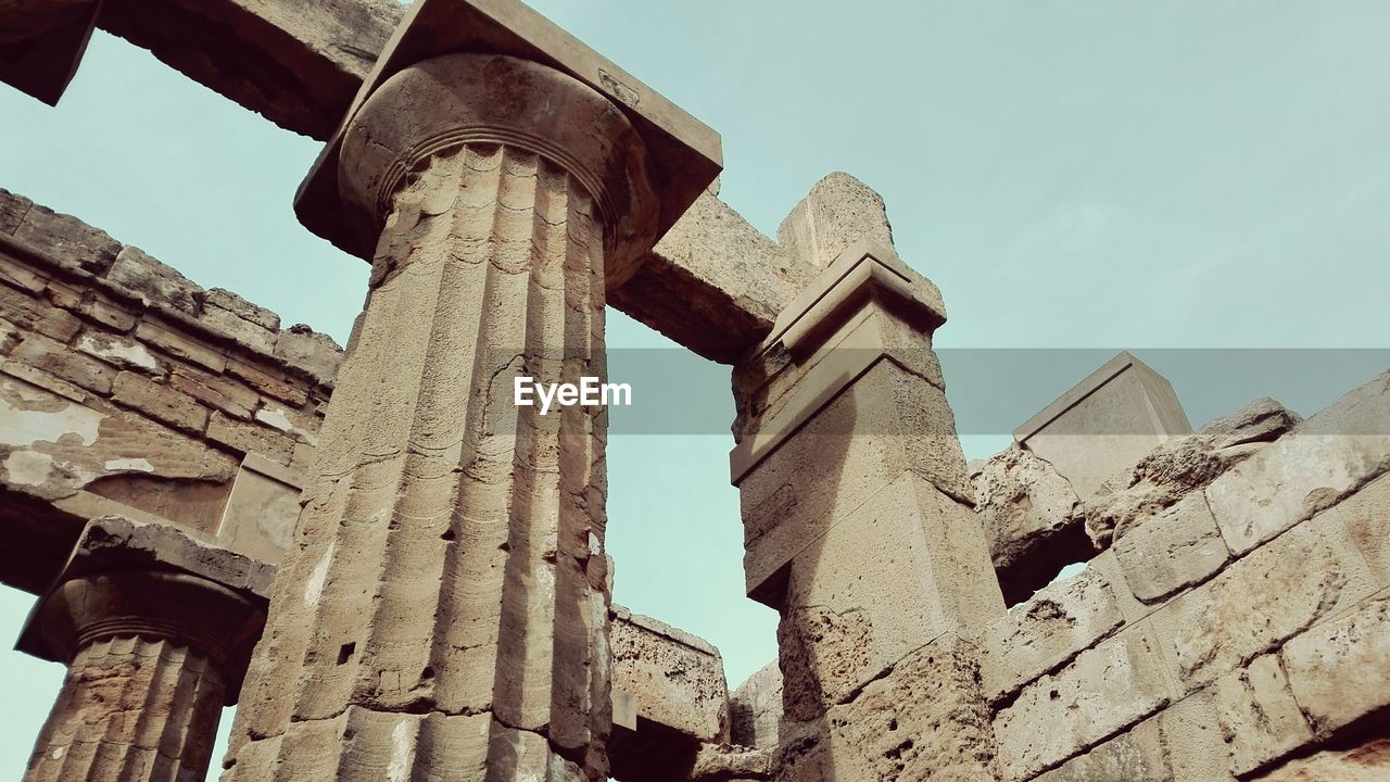 Low angle view of old ruins against clear sky