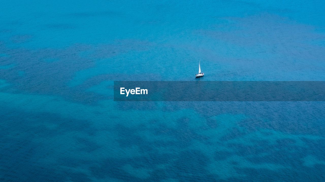 Aerial view of sailboat on sea against sky